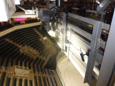 Indoor arena with rows of seats and lights.