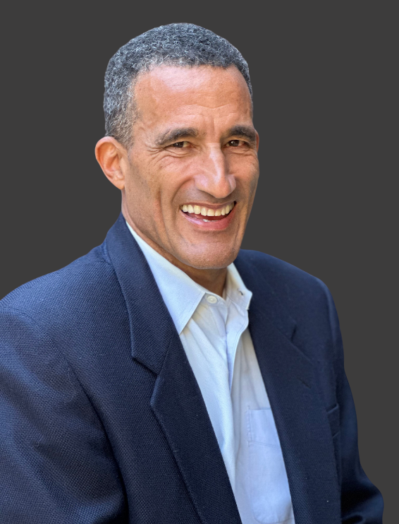 Smiling man in a blue suit and white shirt.