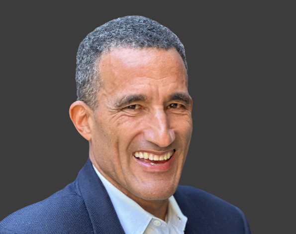 Smiling man in suit headshot portrait.