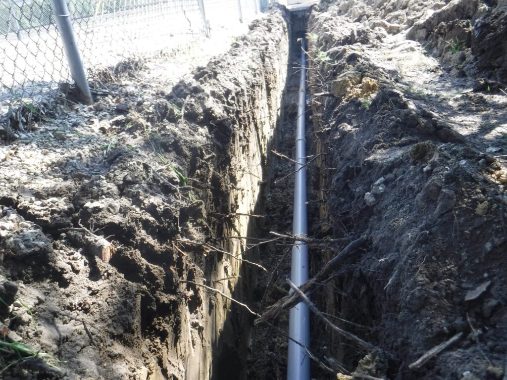 Pipe in a trench with roots.