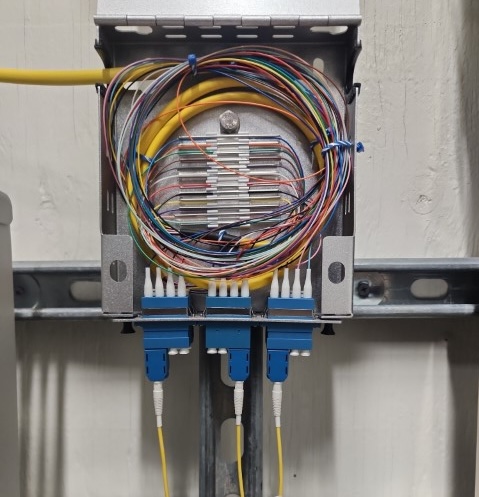 Fiber optic cables in a wall box.