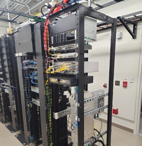 Server rack with network equipment and cables.